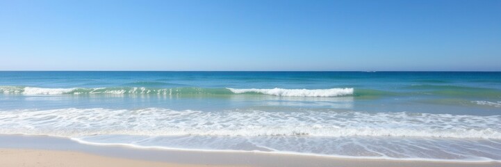 Glistening sea water ocean wave crashing on sandy beach under clear blue sky, nature, beach
