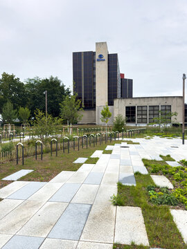 Paris, France - Sep 11, 2024: View of Hilton Hotel in Strasbourg with modern architecture, surrounded by greenery, a landscaped pathway, and bike racks in the foreground.