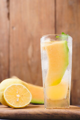 Melon juice, lemonade in a glass with ice and melon slices decorated with mint leaves. Fresh summer drink concept. Ramadan -kareem.
