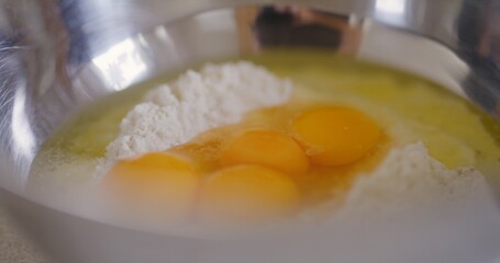 Close-up of raw eggs in flour in bowl