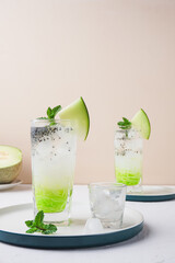 ice melon nata de coco, a drink with a cold sweet taste consisting of a mixture of melon syrup, melon fruit, nata de coco, basil seeds and soda