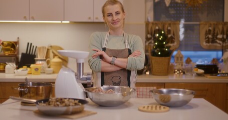 Satisfied woman in kitchen background while working smiling and happy