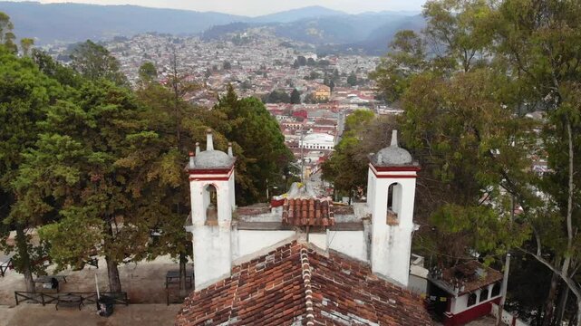 Aerial Drone shot of Church Iglesia de San Cristobalito on the mountain in San Cristobal de Las Casas, Chiapas, Mexico