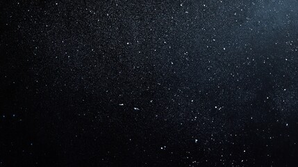 Abstract black and blue background with scattered white specks.