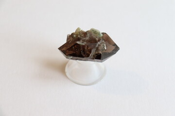 A smokey quartz on a white background. Gemstones and crystals. A close-up of stones and geologic...