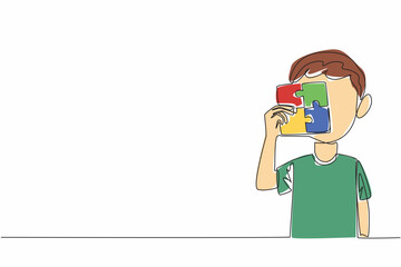Single continuous line drawing little boy holding a 4 piece square puzzle. Colorful puzzles help to focus. Various treatment methods. World Autism Awareness Day. One line design vector illustration