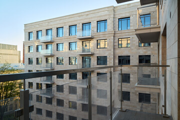 Fototapeta premium A modern apartment building featuring attractive balconies and sleek glass railings