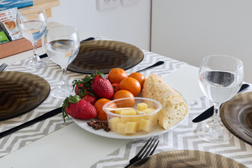 A beautiful Fresh Fruits and Cheese Platter placed on a Stylish Dining Table for enjoyment