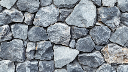 Obraz premium Rough stone wall with irregularly shaped rocks