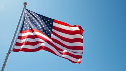 Obraz premium American Flag Waving in a Clear Sky - High-Resolution Image, USA Flag, Patriotic, Blue Sky, Proud, Majestic, Freedom, National Symbol, Stars and Stripes, Outdoor, American Pride, Patriotic Image