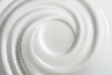Obraz premium Swirling white cream texture on a smooth surface in soft lighting. Generative AI