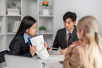 Diverse Business Team Collaborating on Strategic Work Plans in a Modern Office Setting