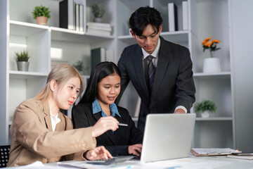 Diverse Business Team Collaborating on Project Plans in Modern Office Setting