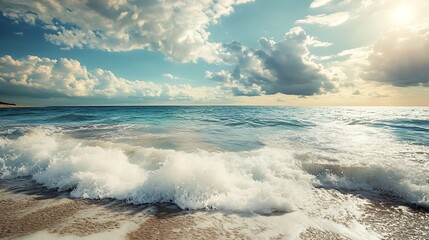 Fototapeta premium Ocean waves crashing on sandy beach at sunset