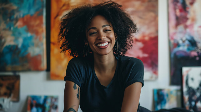 Joyful female artist sitting vibrant studio colorful artwork creativity passion artistic expression space content artistic lifestyle smile happy confident dark skin white blonde black hair painter