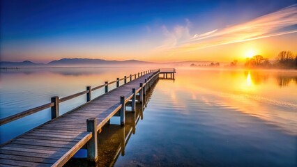Naklejka premium Pier at Lake Chiemsee at Sunrise with fog on water, pier, lake, Chiemsee, sunrise, fog, water, reflection, serene, tranquil