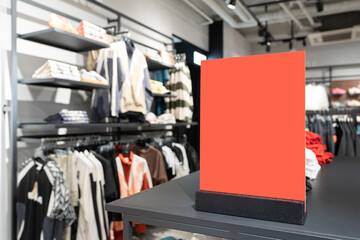 Red blank sign inside shopping mall. mock up advertise display frame setting over the clothes line...