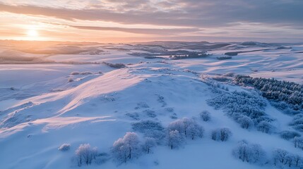 Obraz premium Aerial view of frost-covered sand dunes glowing under the soft light of a winter sunrise