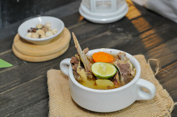 bone soup in a white bowl