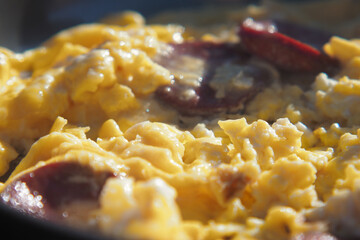 Enjoy delicious scrambled eggs with sausage in a sizzling frying pan
