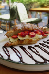 Enjoy a Delicious Croissant Dessert Filled with Bananas and Strawberries