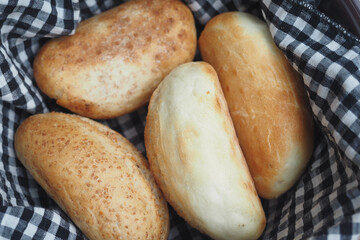 Freshly Baked Soft Bread Rolls Presented in a Charming Checkered Basket