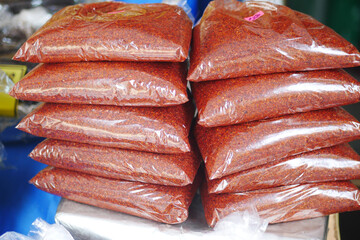Piles of Spicy Chili Powder Organized in Clearly Labeled Bags for Sale