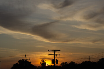 Silhouette of sunset sky and cloud at the city background.