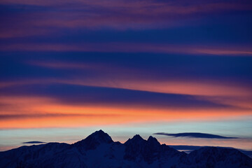 Winter sunrises over Alaska's Chugach Range are often colorful spectacles of sunlight and clouds.