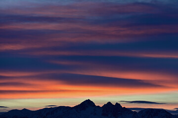 Winter sunrises over Alaska's Chugach Range are often colorful spectacles of sunlight and clouds.