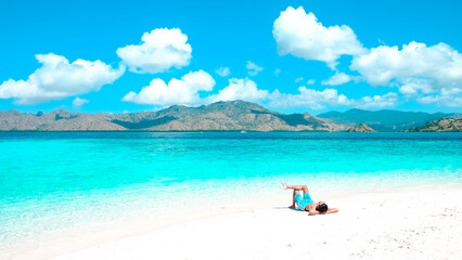 Man sunbathing outdoor tanning at sea beach. Summer travel vacation.