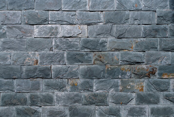 A brick wall with a grey color