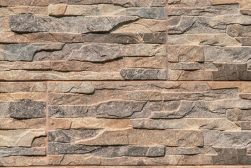 A wall made of stone with a brown and gray color