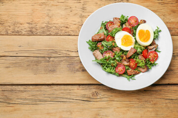 Delicious fresh tuna salad on wooden table, top view. Space for text