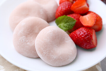 Delicious mochi and strawberries on table, closeup