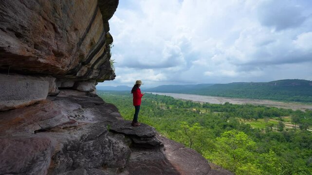 4k video,Female tourist walks around and taking photos at Pha Taem  national park. Ubon Ratchathani, Thailand
