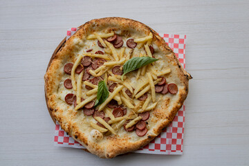 An appetizing pizza with a crispy base, aromatic pesto sauce, melted mozzarella cheese and fresh cherry tomatoes.