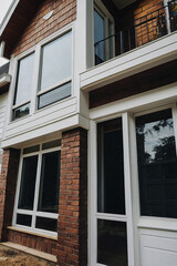 Brick House Exterior with Multiple Windows and Door