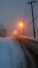 A serene winter scene featuring a snowy road shrouded in fog with glowing streetlights illuminating the path.