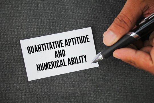 pen and paper with the words quantitative aptitude and numerical ability. Quantitative aptitude includes operations related to logic and expressions whereas numerical ability relates to numbers.