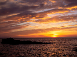 Colourful coastal sunrise on horizon