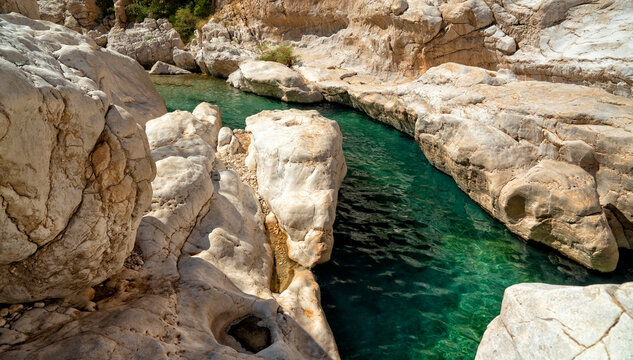 Oman. Oasis Wadi Bani Khalid. Lagoon with fresh emerald water and beautiful rocks	