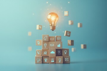 A glowing light bulb floating above a stack of wooden cubes, each engraved with different creative icons and symbols, against a soft blue background, symbolizing innovative thinking and new ideas.