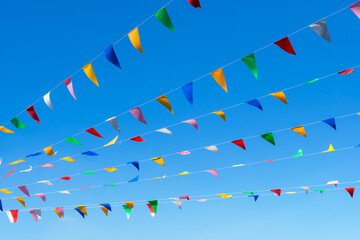 Colorful prayer flags on blue sky. traditional carnival decorative.