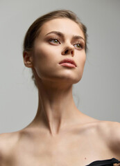 Elegant young woman with natural makeup and a sophisticated pose, showcasing beauty and confidence...