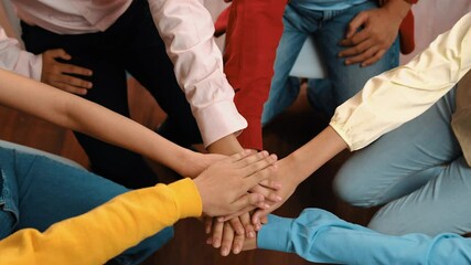 Startup company employee team gladly stacking hand together symbolize successful group of business partnership and strong collective unity teamwork in community workplace in panoramic video. Synergic