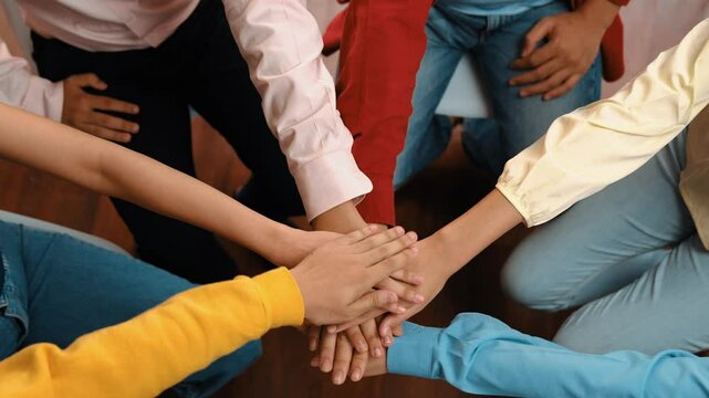 Startup company employee team gladly stacking hand together symbolize successful group of business partnership and strong collective unity teamwork in community workplace in panoramic video. Synergic