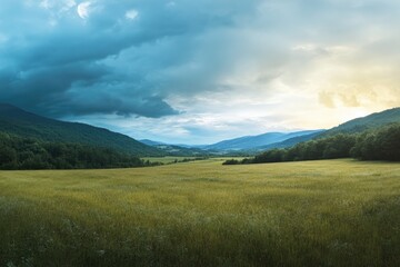 Obraz premium Summer landscape with rural fields in mountains under cloudy sky