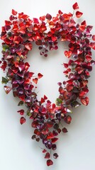 Obraz premium heart shaped wreath created from vibrant red autumn leaves and foliage symbolizing love romance and the beauty of nature The delicate and elegant arrangement evokes feelings of tenderness passion