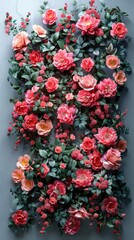 Vibrant and Romantic Rose Flower Arrangement in Greenhouse Setting  Lush and Blooming Floral Bouquet with Vibrant Red and Pink Roses Greenery and Foliage in Cozy and Moody Greenhouse Environment